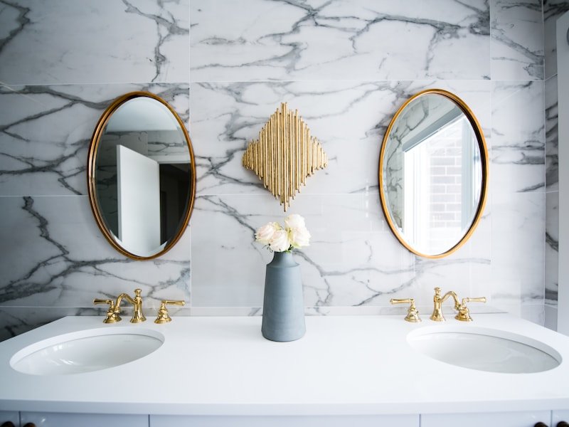 Luxury Toronto bathroom interior with marble walls and brass fixtures, context for a glass door upgrade